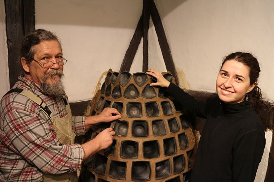 Johannes Klett und Nadine Holesch vor ihrem neuen "alten" Kachelofen (Foto: Angelo Glashagel)